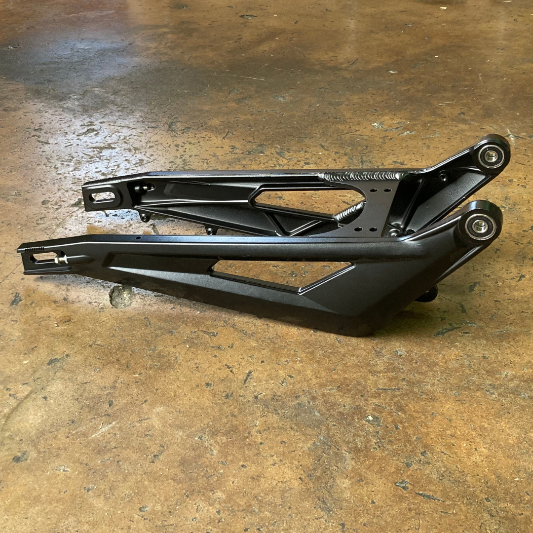 Surron OEM Swingarm for electric dirt bikes, side view. Color: Black 